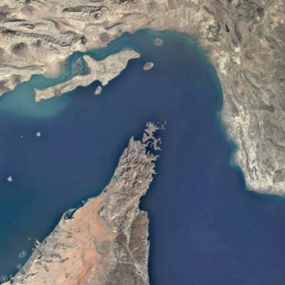 Satellite view of the Strait of Hormuz showing the narrow waterway between Iran (top) and the Arabian Peninsula, a critical global oil shipping route.