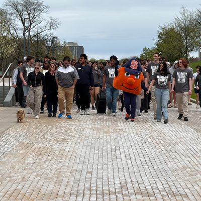 Otto the Orange leads participants down the Einhorn Family Walk to Crouse-Hinds Hall.