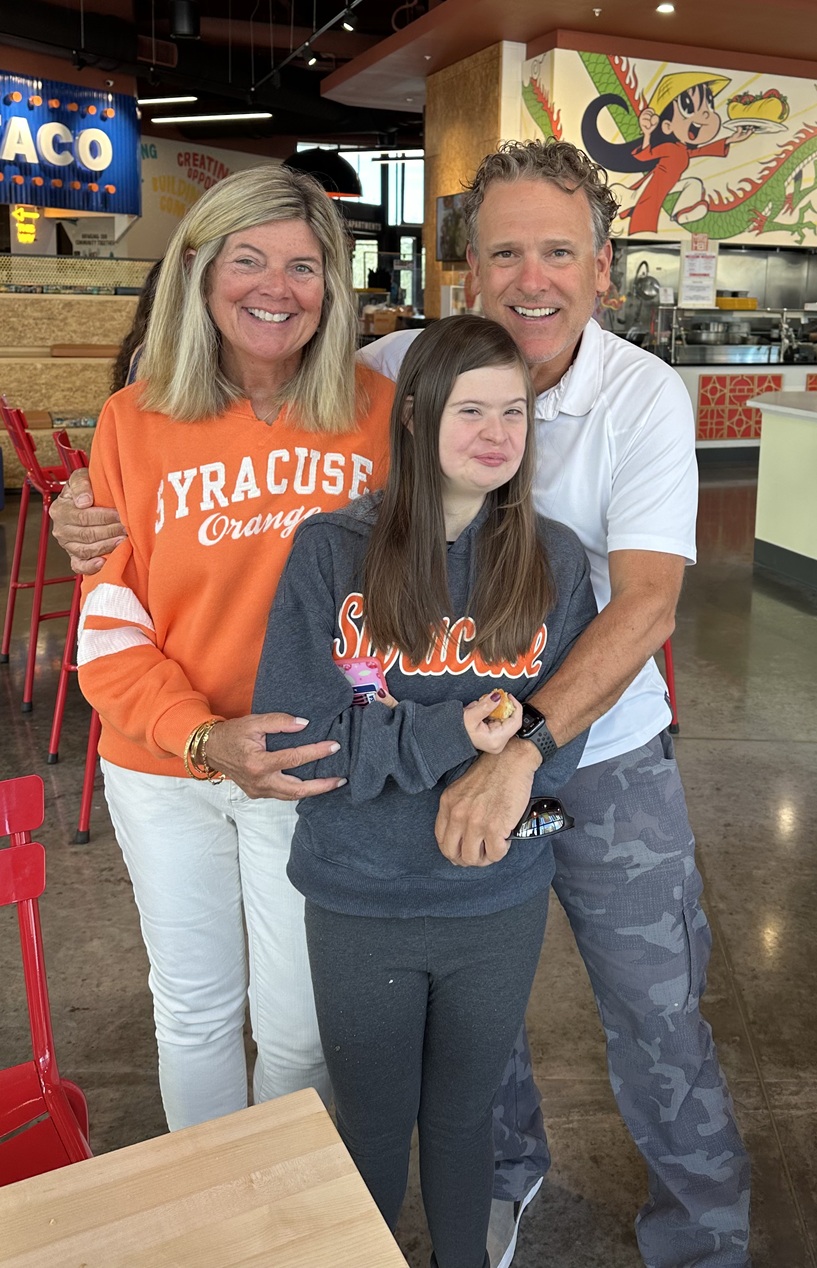 three people standing in a restaurant