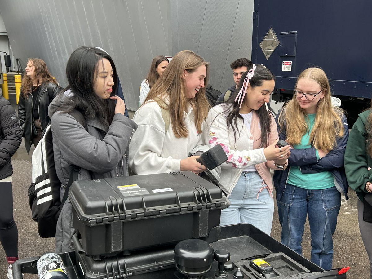Students examine field detection equipment outdoors during a CBRN training exercise on South Campus.