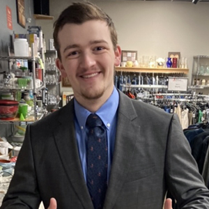 A student smiles while posing for a headshot.