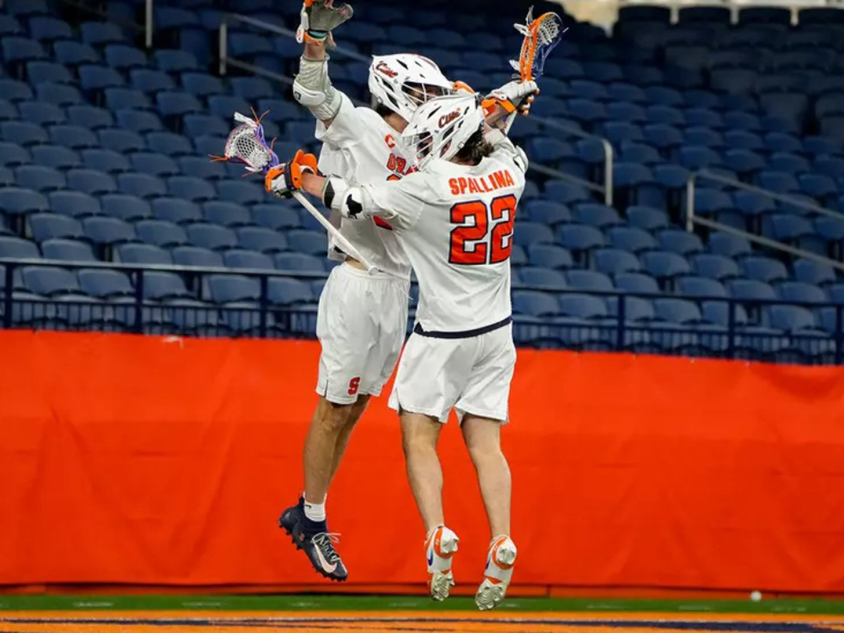 Two members of the men's lacrosse team celebrate after a goal was scored.