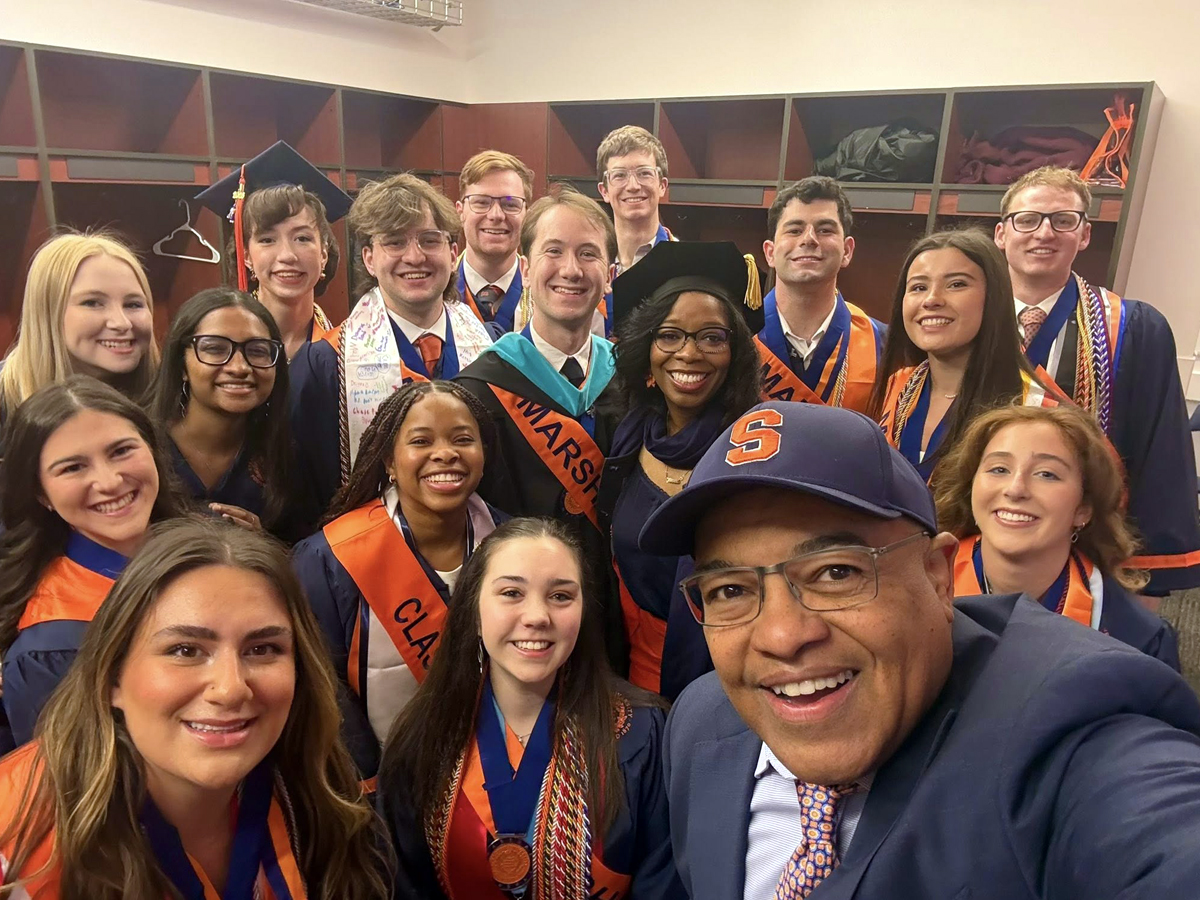 The commencement speaker takes a selfie with the senior Class Marshals before Commencement.