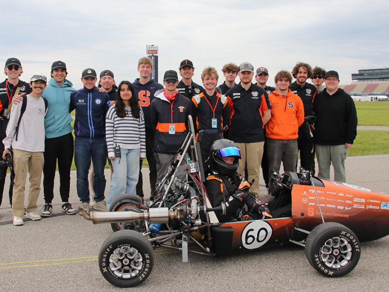 The 2025-2026 Citrus Racing Team poses with their car at the Formula SAE event in Michigan