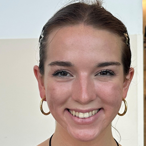 A person smiles while posing for a headshot.