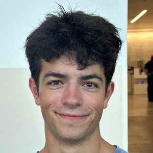 A person smiles while posing for a headshot.