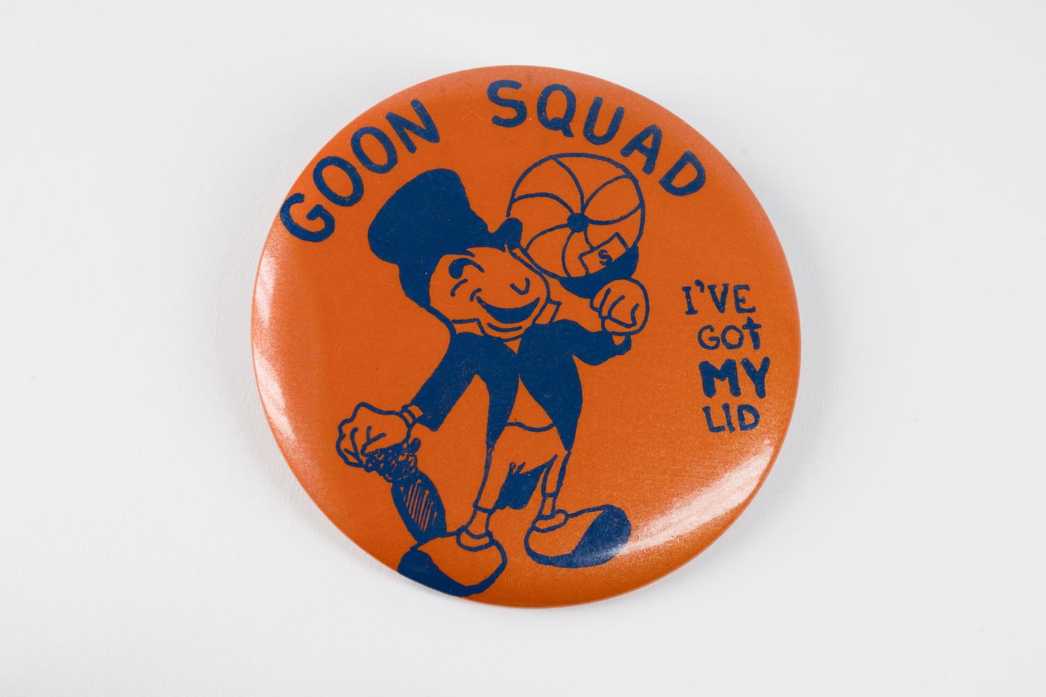 Orange pinback button featuring a cartoon mascot spinning a basketball, with the text “GOON SQUAD” and “I’VE GOT MY LID.”