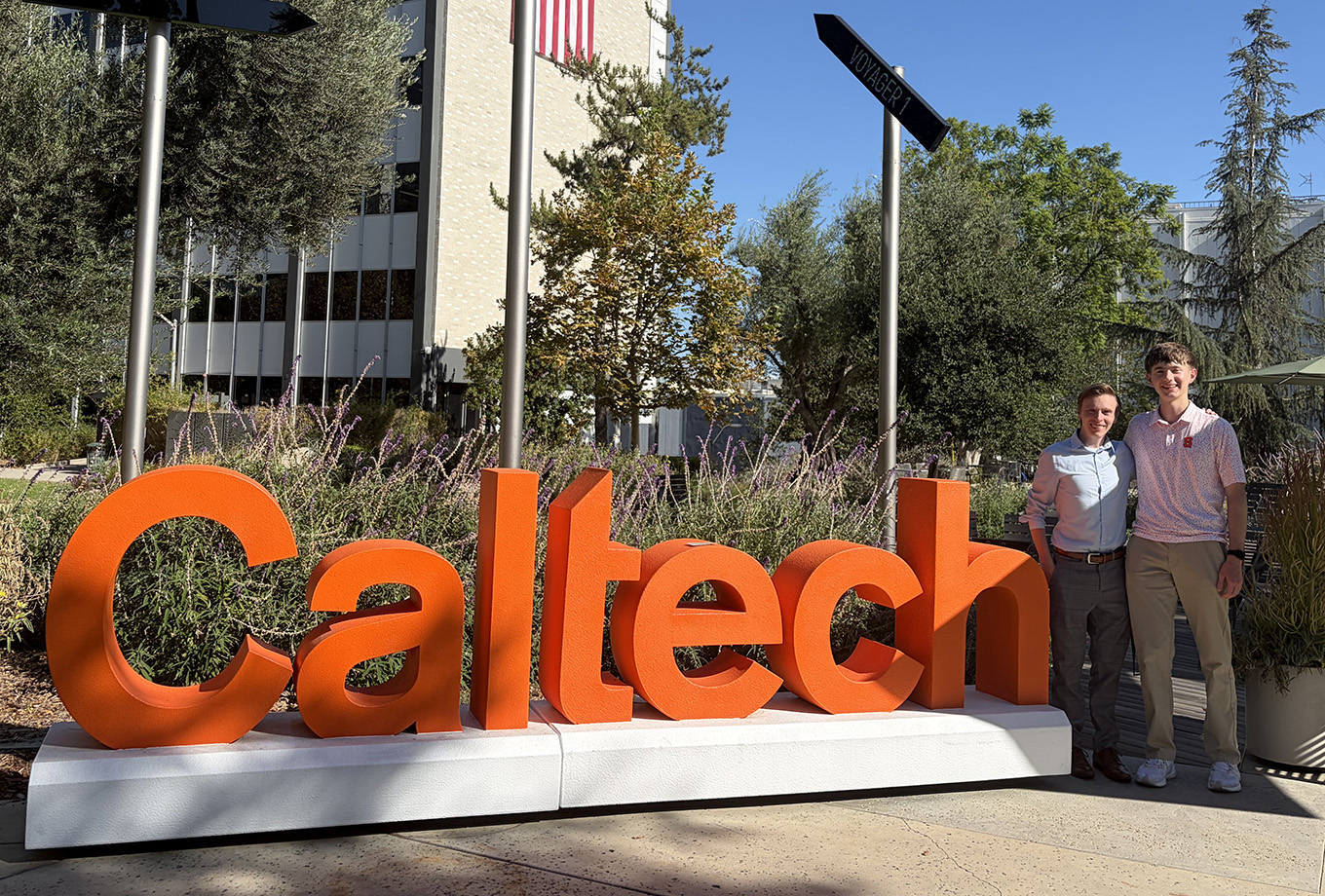 Andrew Uryniak and Shaun Ryan posing by the Caltech sign