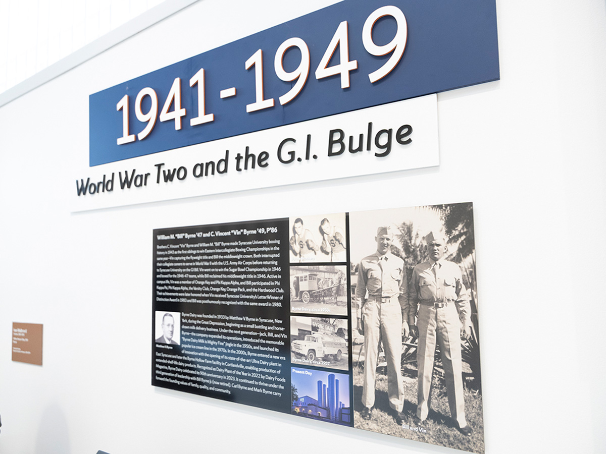 Museum exhibit panel titled "1941–1949: World War Two and the G.I. Bulge," honoring brothers William "Bill" Byrne and C. Vincent "Vin" Byrne. The display includes historical photos of Byrne Dairy trucks and facilities, plus a portrait of the two brothers in military uniform, alongside text describing their Syracuse University boxing achievements and family dairy business history.