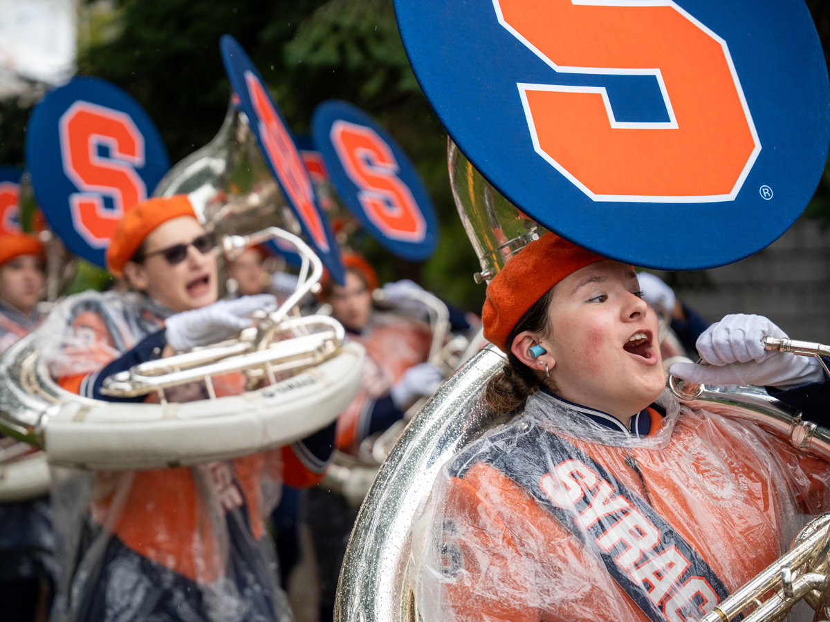 Members of the Syracuse University Marching Band perform in the rain.