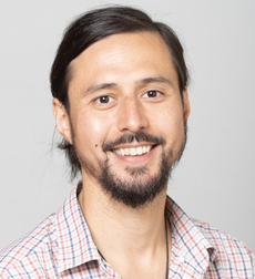 Headshot of Josh Pollitz, assistant professor of mathematics at Syracuse University, smiling in front of a neutral background.