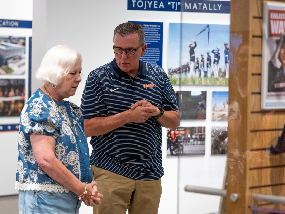 Man and woman viewing exhibit together near a display.