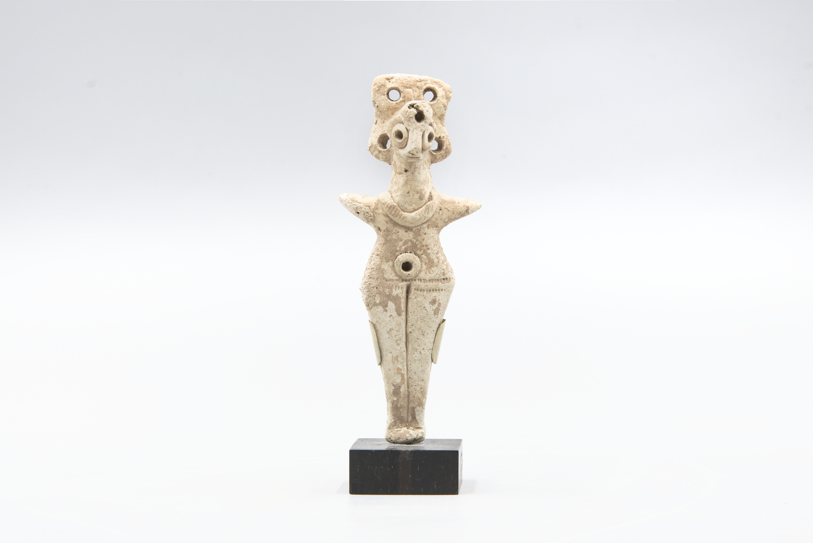 Ancient terracotta figurine of a stylized human figure
