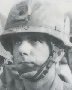 Black-and-white photo of Col. Fortunato "Fred" Priore in military helmet and gear.