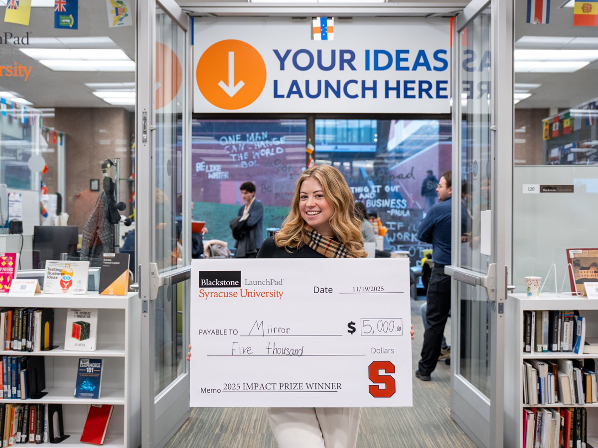 Haley Greene holds an oversized $5,000 check for Miirror at the Blackstone LaunchPad.