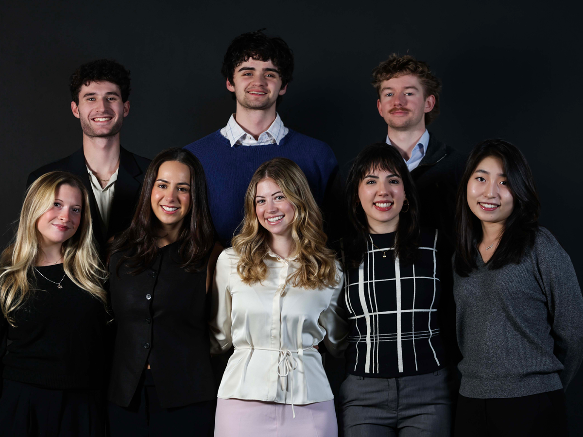 Group portrait of the nine-member Miirror team standing together for a photo.