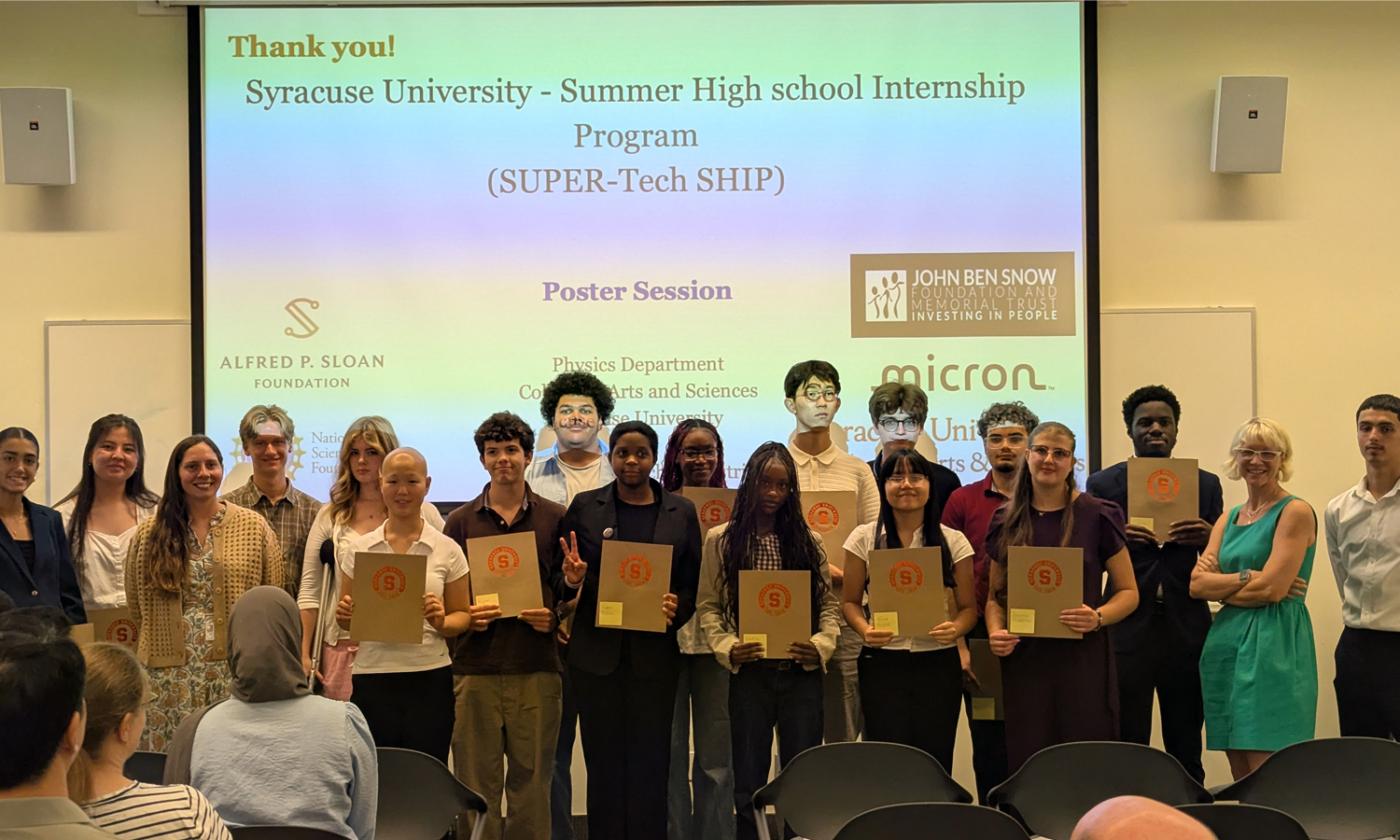 SU-SHIP student interns pose with certificates on stage after poster session.