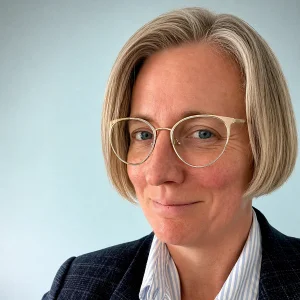 A person smiles while posing for a headshot.