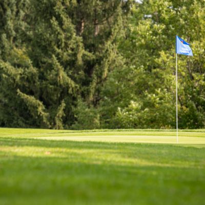 A golf flag sits in the hole on the Drumlins Country Club.