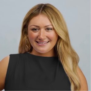 A student smiles while posing for a headshot.