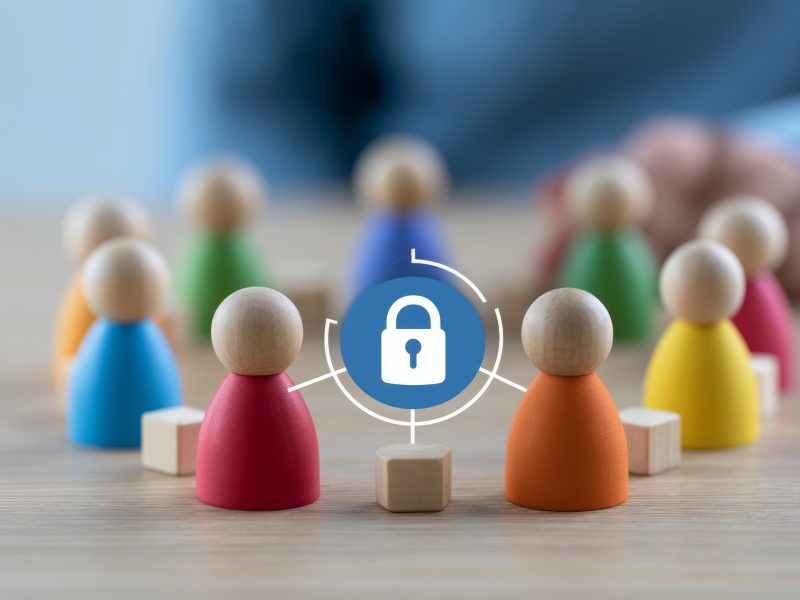 Colorful wooden figures in a circle around a padlock icon, connected to it by thin lines.
